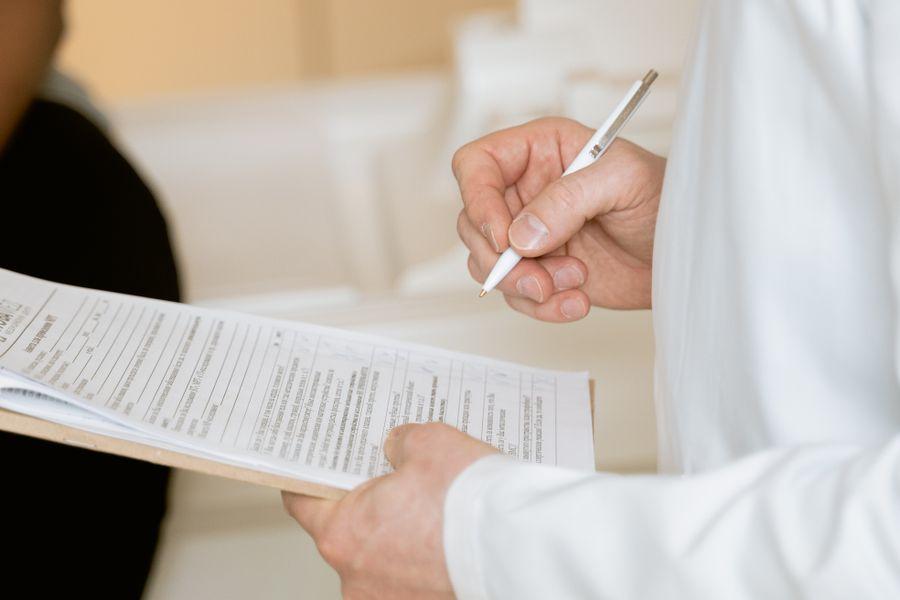 Professional reviewing health and benefits forms during a consultation