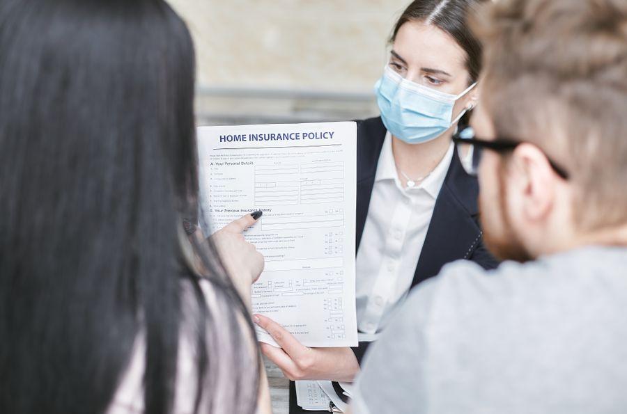 Insurance professional explaining policy documents to clients
